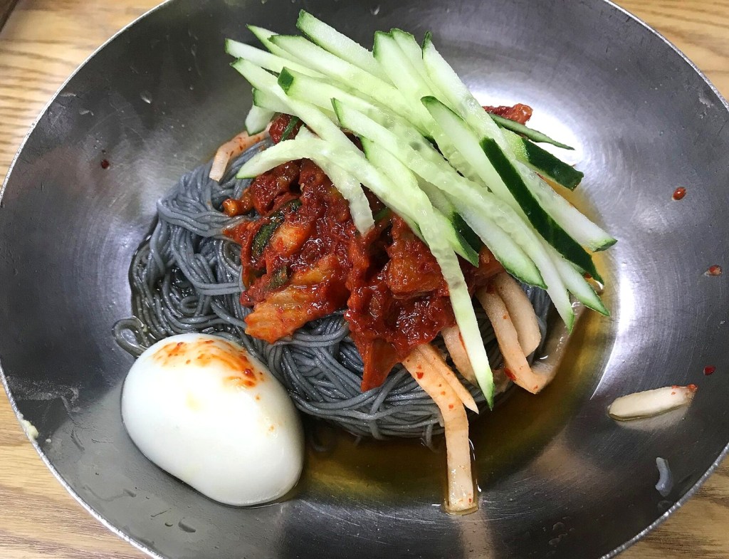 Bibim naengmyeon, spicy Korean cold noodles mixed with red gochujang sauce — naengmyeon winter origin