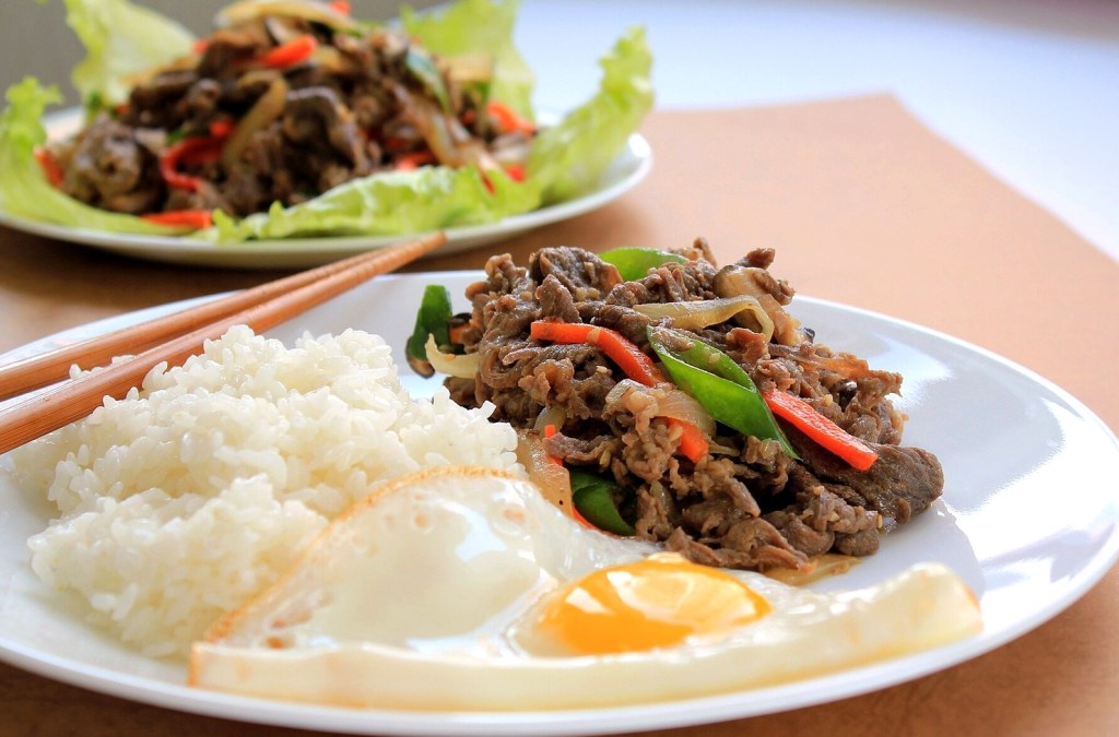 Bulgogi, thin marinated Korean beef, grilling with onions — korean bbq sejong