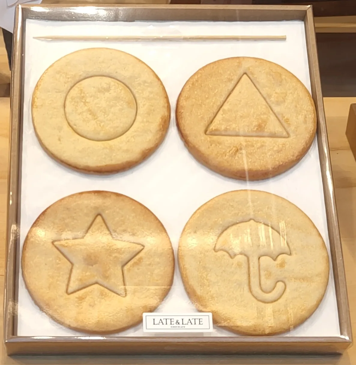 Korean dalgona candies stamped with the four Squid Game shapes: circle, triangle, star, and umbrella — squid game dalgona