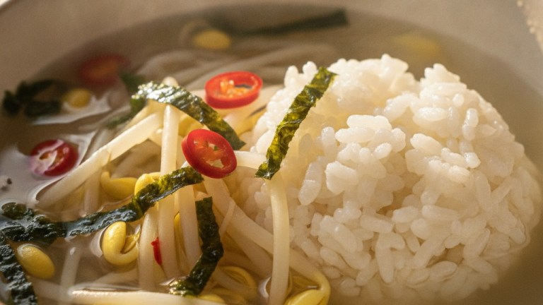 Close up of kongnamul-gukbap showing bean sprouts clear broth rice and crumbled dried seaweed — kongnamul gukbap jeonju