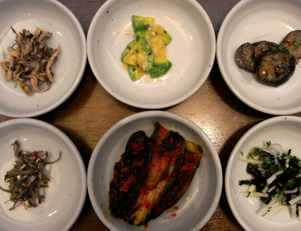 An overhead spread of Korean banchan, small vegetable and fermented side dishes — korean diet king