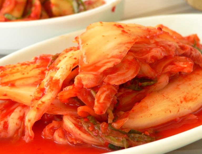 Assorted Korean kimchi and fermented side dishes in bowls — korean diet king
