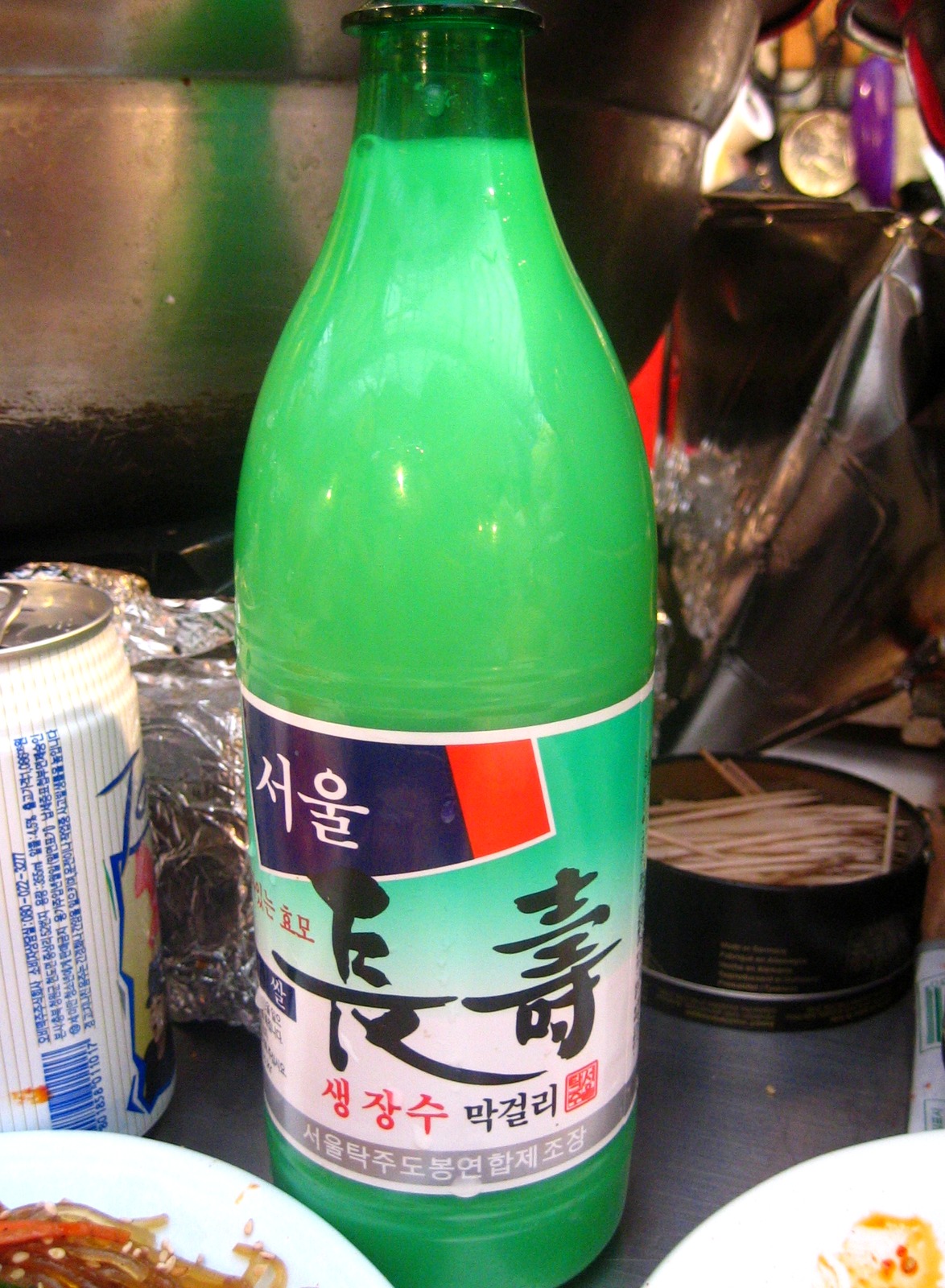 A bottle of Korean makgeolli rice wine on a table — makgeolli korean rice