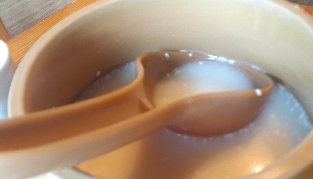 Makgeolli, milky Korean rice wine, poured into a brass bowl — makgeolli korean rice