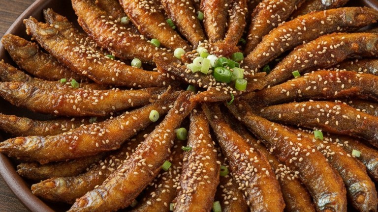 Dori-baengbaeng-i small freshwater fish fried and arranged in a circle glazed with red gochujang sauce in a pan — okcheon saengseon guksu