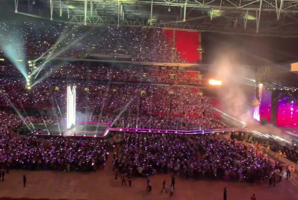 A stadium light-stick ocean at a BTS Love Yourself Speak Yourself date — stray kids disband