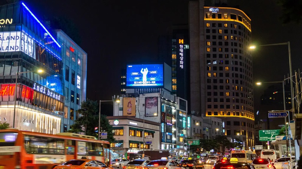 Myeongdong at night — the neighborhood crowds that follow a K-pop wave — bts neighborhood effect