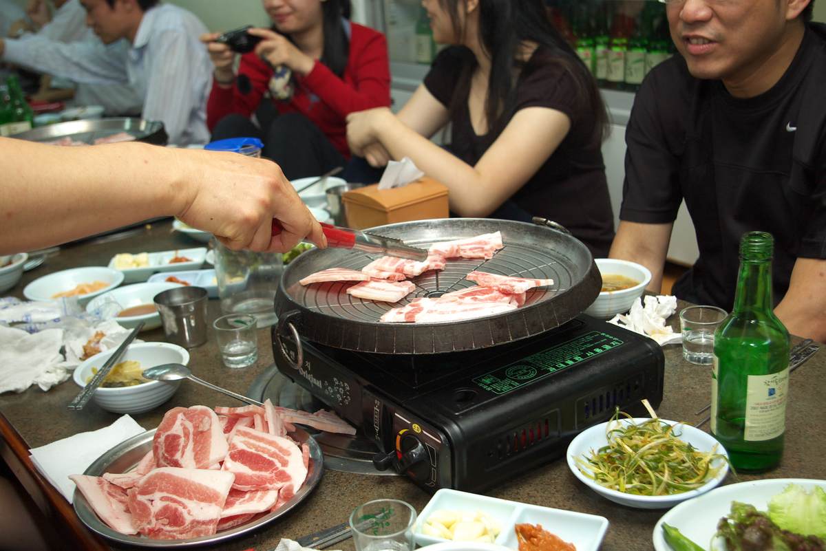Samgyeopsal, Korean grilled pork belly, cooking on a barbecue grill — stray kids disband