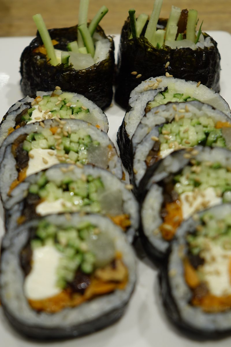 Gimbap, Korean seaweed rice rolls, sliced and arranged on a plate — bts neighborhood effect