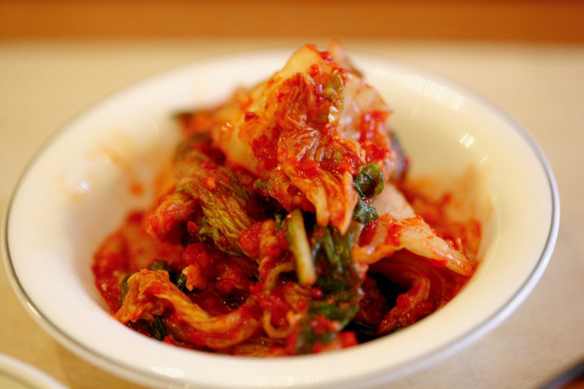 A plate of red napa cabbage kimchi, Korea's fermented national dish — kimchi europe health