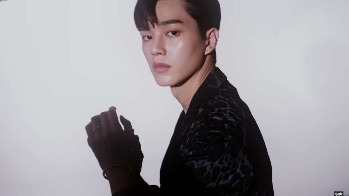 Portrait of Korean actor Song Kang in a dark suit, editorial photo — song kang military