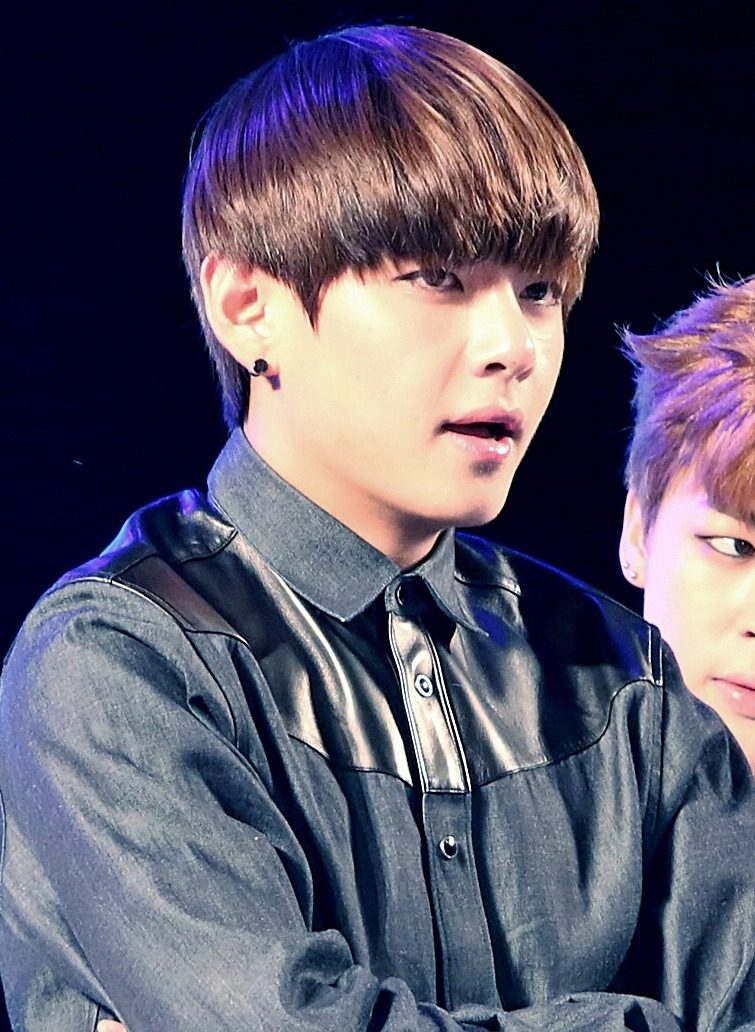 V of BTS performing on stage during a concert — bts hangul typeface