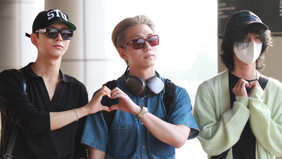 Xdinary Heroes members making heart hand gestures at the airport — sasaeng fan explained